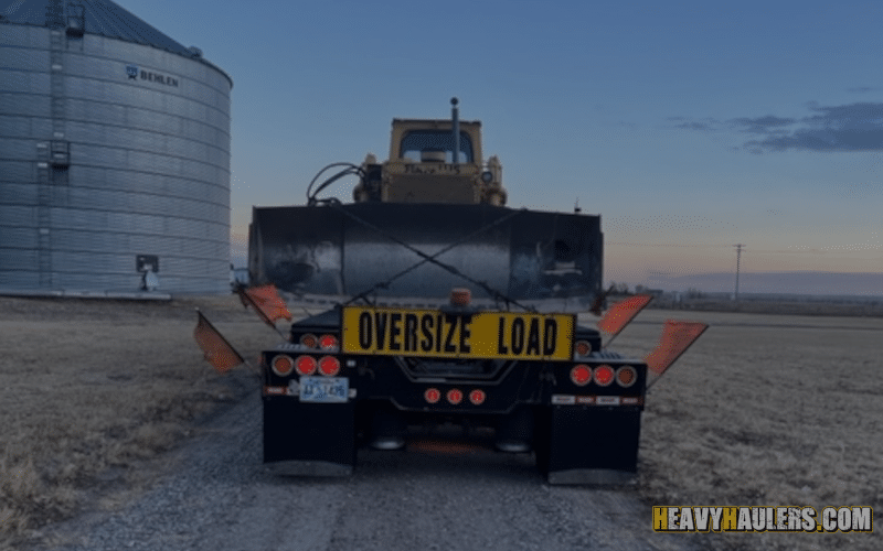 Transporting an oversize bulldozer on a flatbed trailer.