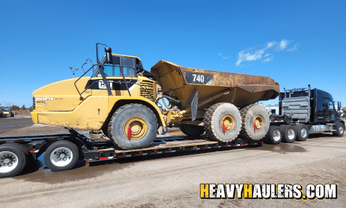 Transporting a rock truck on a lowboy trailer.