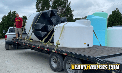 Transporting water tanks on a hot shot trailer.