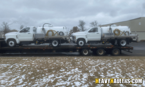 Transporting two tank trucks during the end of winter.