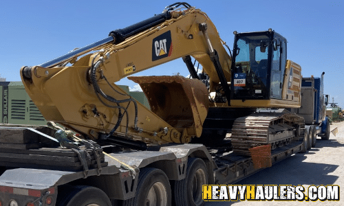 CAT Excavator loaded for transport on a lowboy trailer