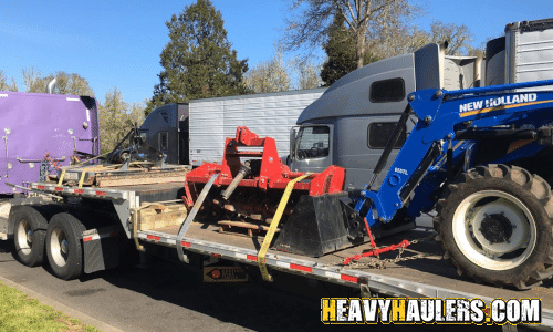 New Holland Tractor and parts loaded for transport
