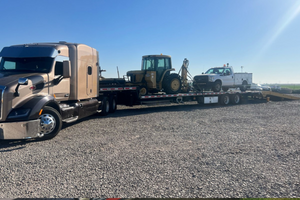 Hauling a JD 6300 Tractor and a 2013 Ford F-350 Service Truck.