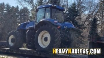Loading a New Holland tractor on a trailer.