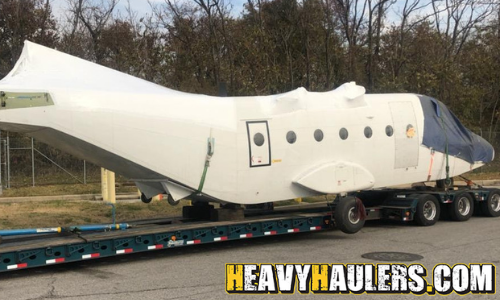 Airplane fuselage on a drop deck trailer