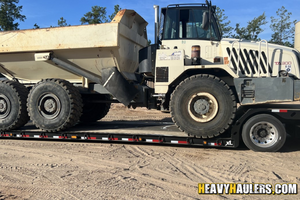 2000 Terex TA300 transported on a lowboy trailer.