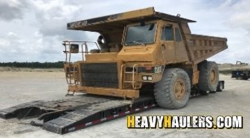 Hauling a Caterpillar 769C articulated dump truck