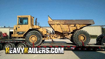 Hauling a Caterpillar D25 articulated dump truck.