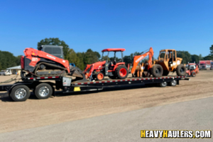 Kubota M62 loader backhoe haul.