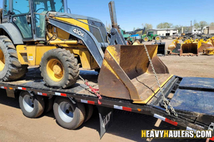 John deere 410k backhoe haul.