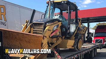 Caterpillar Backhoe on a trailer.