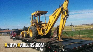 Backhoe transport on a trailer.