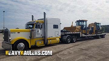 Backhoe transported on a step deck trailer.