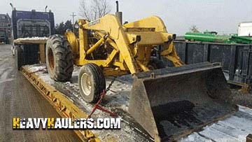 John Deere JD400 Retroexcavadora en transporte