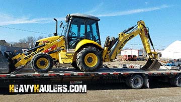 New Holland B95B Retroexcavadora en transporte