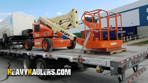 Loading a 1997 electric boom lift for transport.