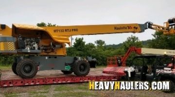 Loading a Haulatte boom lift on a trailer.