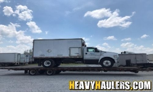 Hauling a box truck on a flatbed.