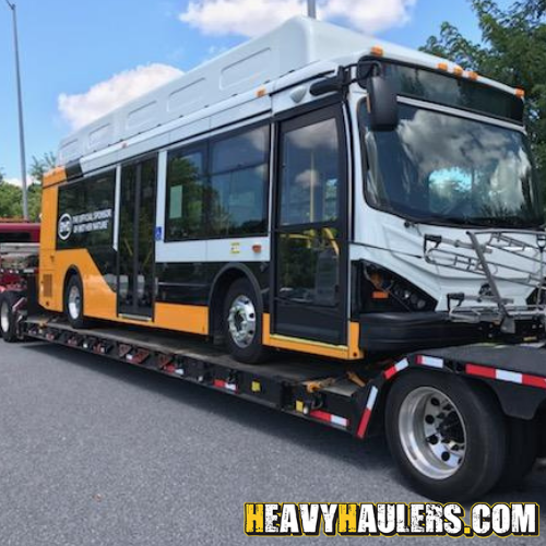 BYD electric bus transported on a drop deck trailer