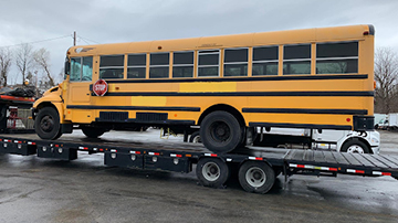 Hauling a 2007 International School Bus Model B.