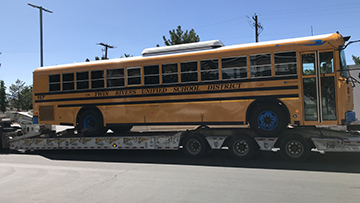 Blue Bird Electric Bus transported on an RGN trailer