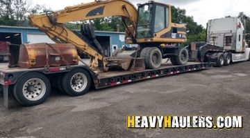 Shipping a mobile excavator on a trailer.