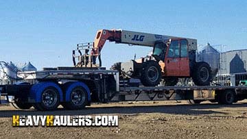 Loading a 26,000lbs JLG boom lift on a step deck trailer.