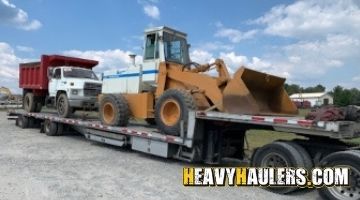 Hauling a front end loader on a step deck trailer.