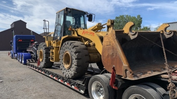 Loading a Caterpillar wheel loader on a trailer.