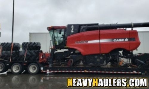 Hauling a Case IH combine on a trailer.