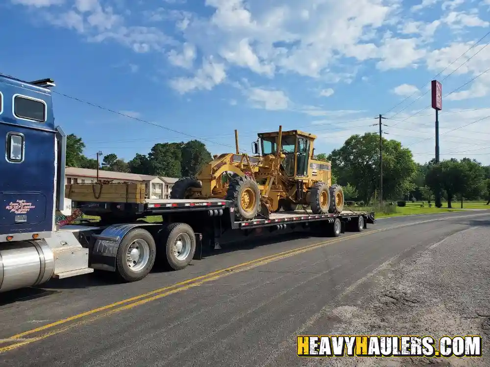 transporting a CAT 12H motor grader