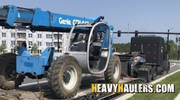 Loading a Genie telehandler on an RGN trailer.