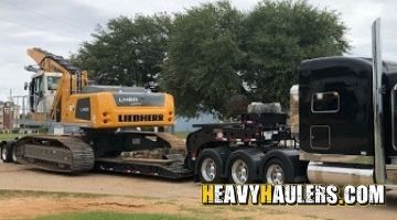 Loading a Liebherr industry litronic excavator on a trailer.