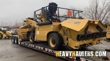 Transporting a quad chip spreader on a trailer to Kansas.