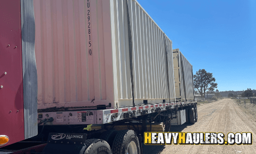 Two containers transported by semi truck.