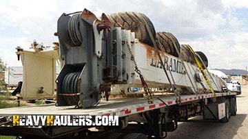 Crane shipped on a flatbed trailer.