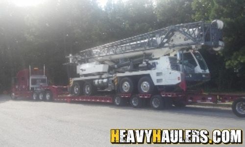 Hauling a Grove crane truck on an RGN trailer.