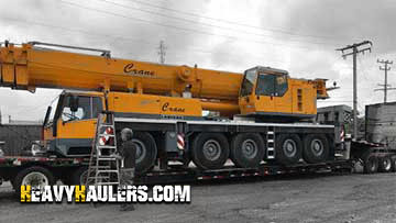 Crane transported on a drop deck trailer.