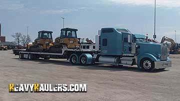 Bulldozer transport on a step deck trailer.