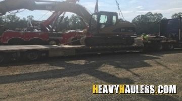 Caterpillar excavator loaded on a trailer.