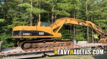Hydraulic excavator shipped on a step deck trailer.