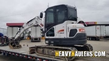 Loading a Bobcat mini excavator on a trailer.