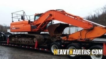 Loading a Doosan excavator on a trailer.