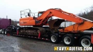 Shipping an excavator on an RGN trailer.
