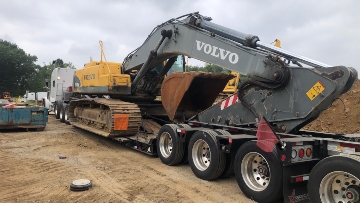 Loading a Volvo excavator on an RGN trailer.