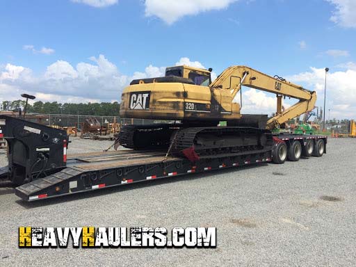 Loading a long reach excavator for transport.