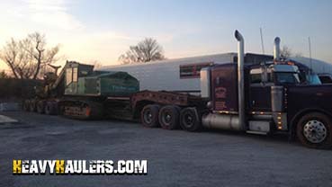 Transporting a Wide Load 1988 Timberjack 850 Feller Buncher.