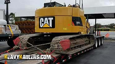 Hauling an oversize excavator on a trailer.