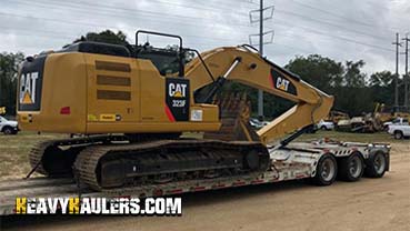 Hualing a Caterpillar excavator from  Maine.
