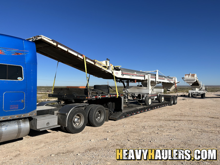 Oversize Wilson Conveyor on an RGN trailer.